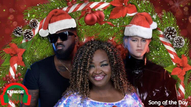 Producer Blizz Bugaddi, Dynelle Rhodes from the Weather Girls, and DJ Gunn standing inside a christmas wreath with santa hats on | Song of the Day Feature | Eat Sleep Breathe Music